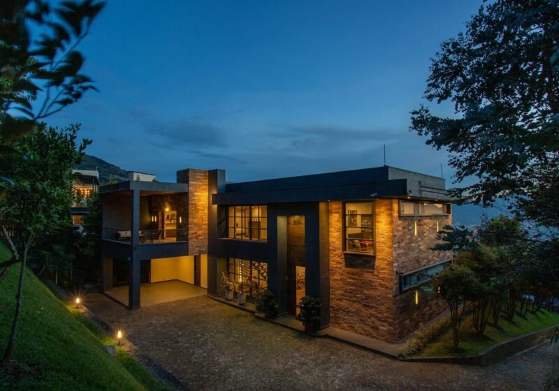 Contemporary luxury villa with warm lighting at dusk