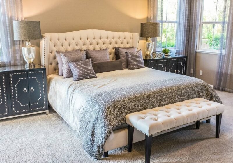 Master bedroom with tufted headboard and upholstered bench