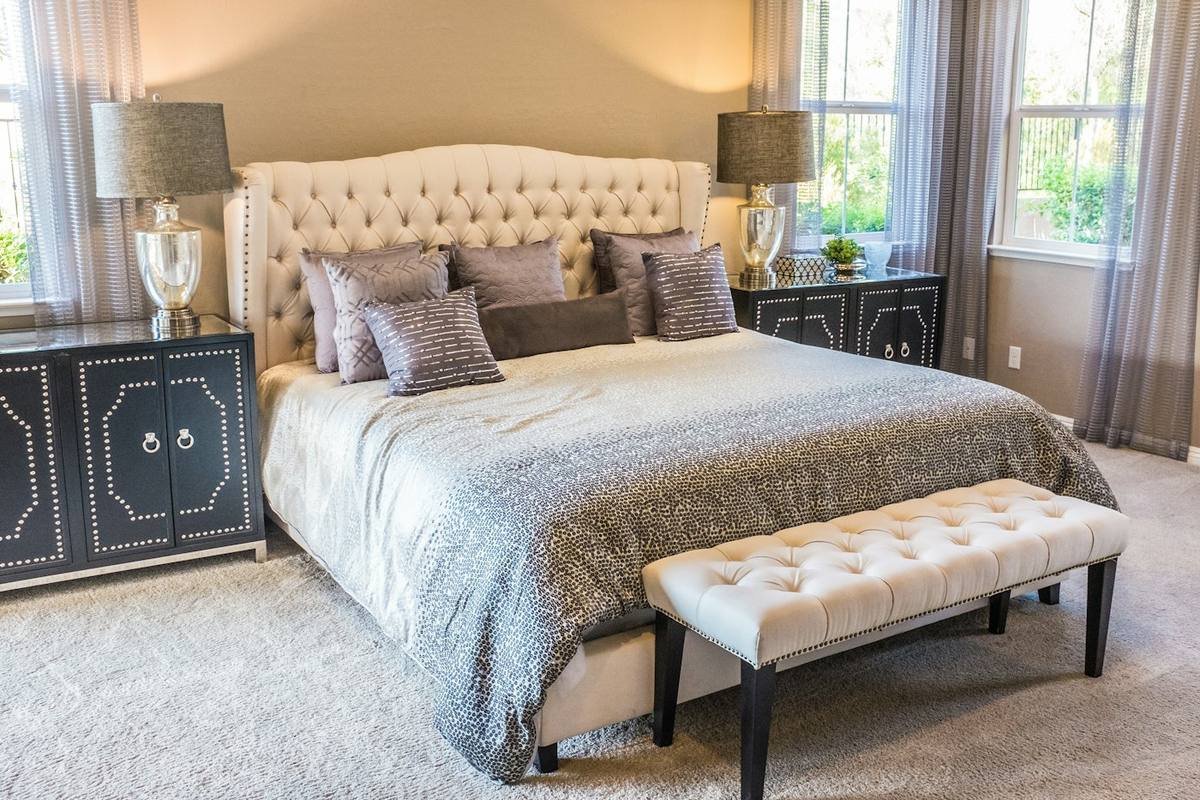 Master bedroom with tufted headboard and upholstered bench