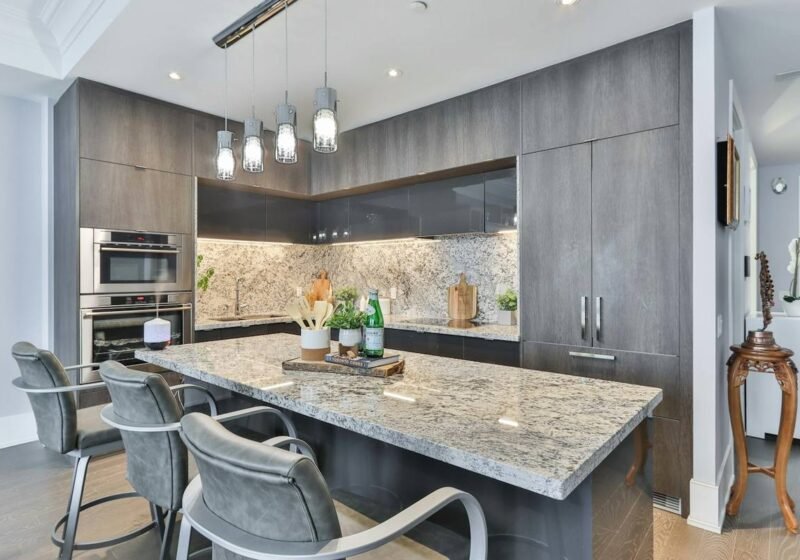 Modern kitchen with stone-topped island and bar seating