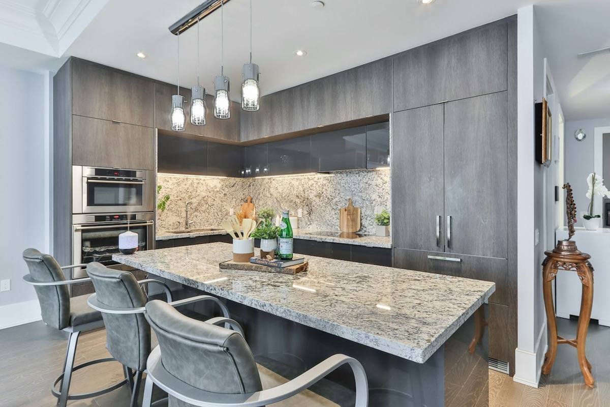 Modern kitchen with stone-topped island and bar seating