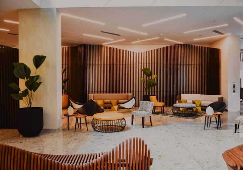 Spacious lounge with wood-panelled walls and designer seating