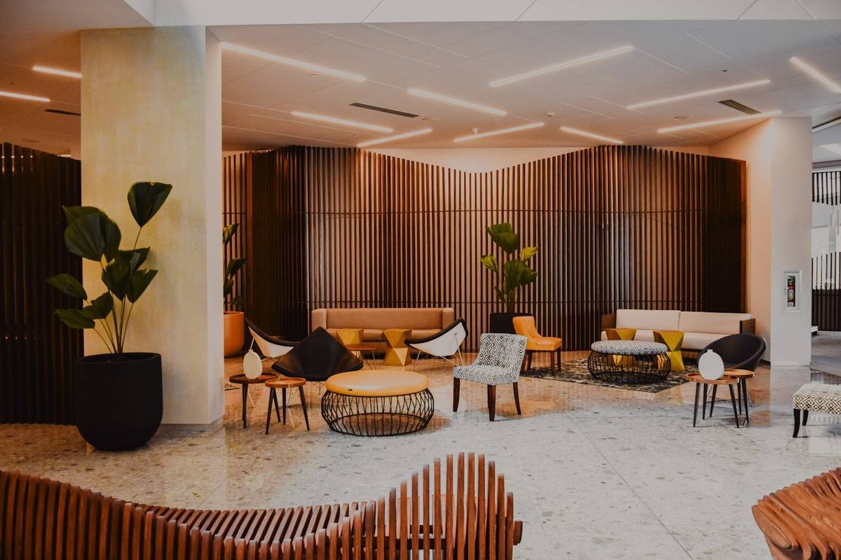 Spacious lounge with wood-panelled walls and designer seating