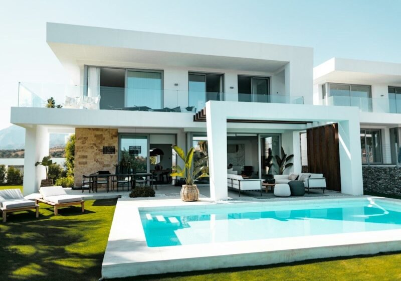 Poolside lounge area of a white contemporary villa